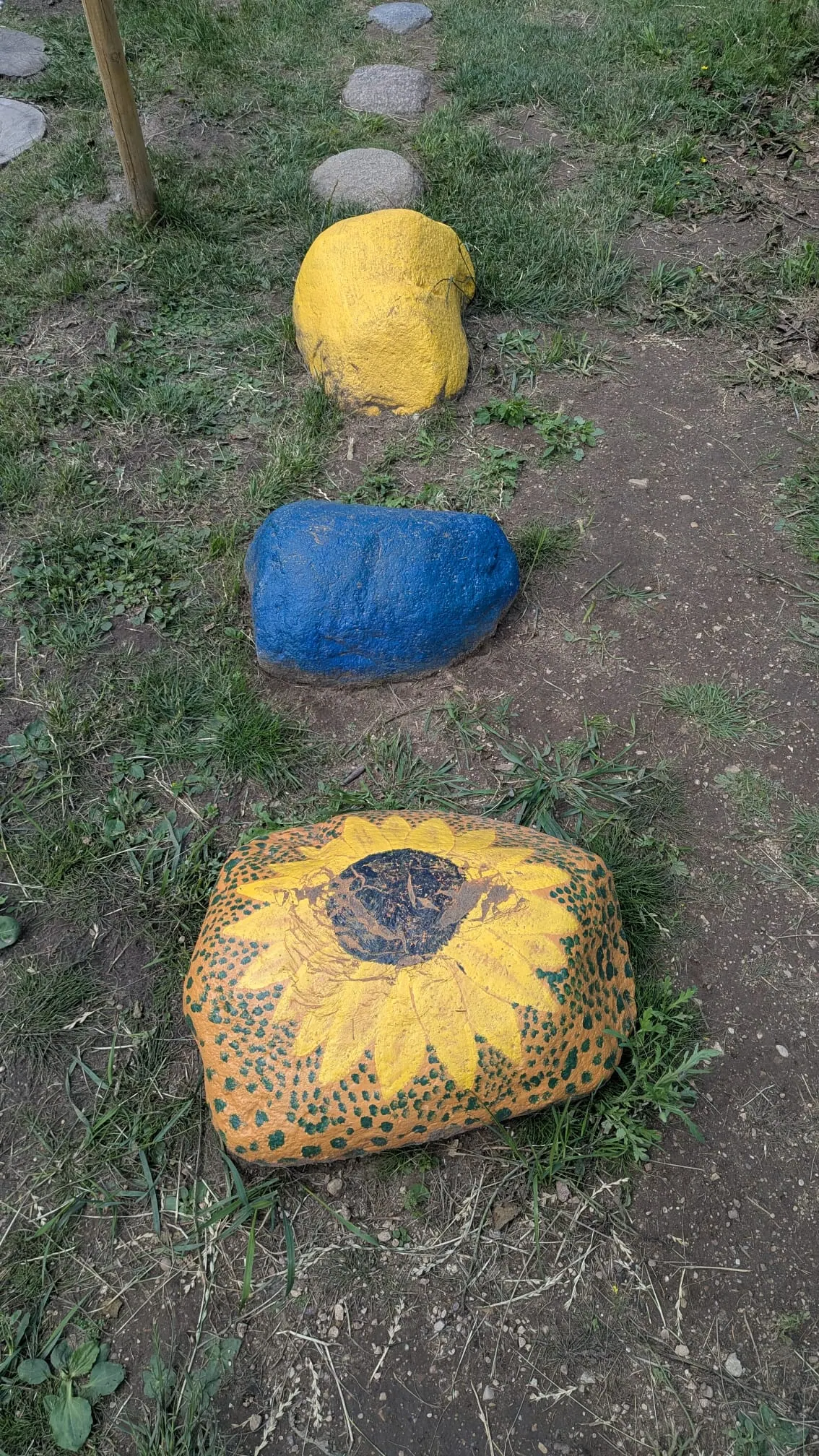 Colourful painted stones along the barefoot trail at Valguma Pasaule