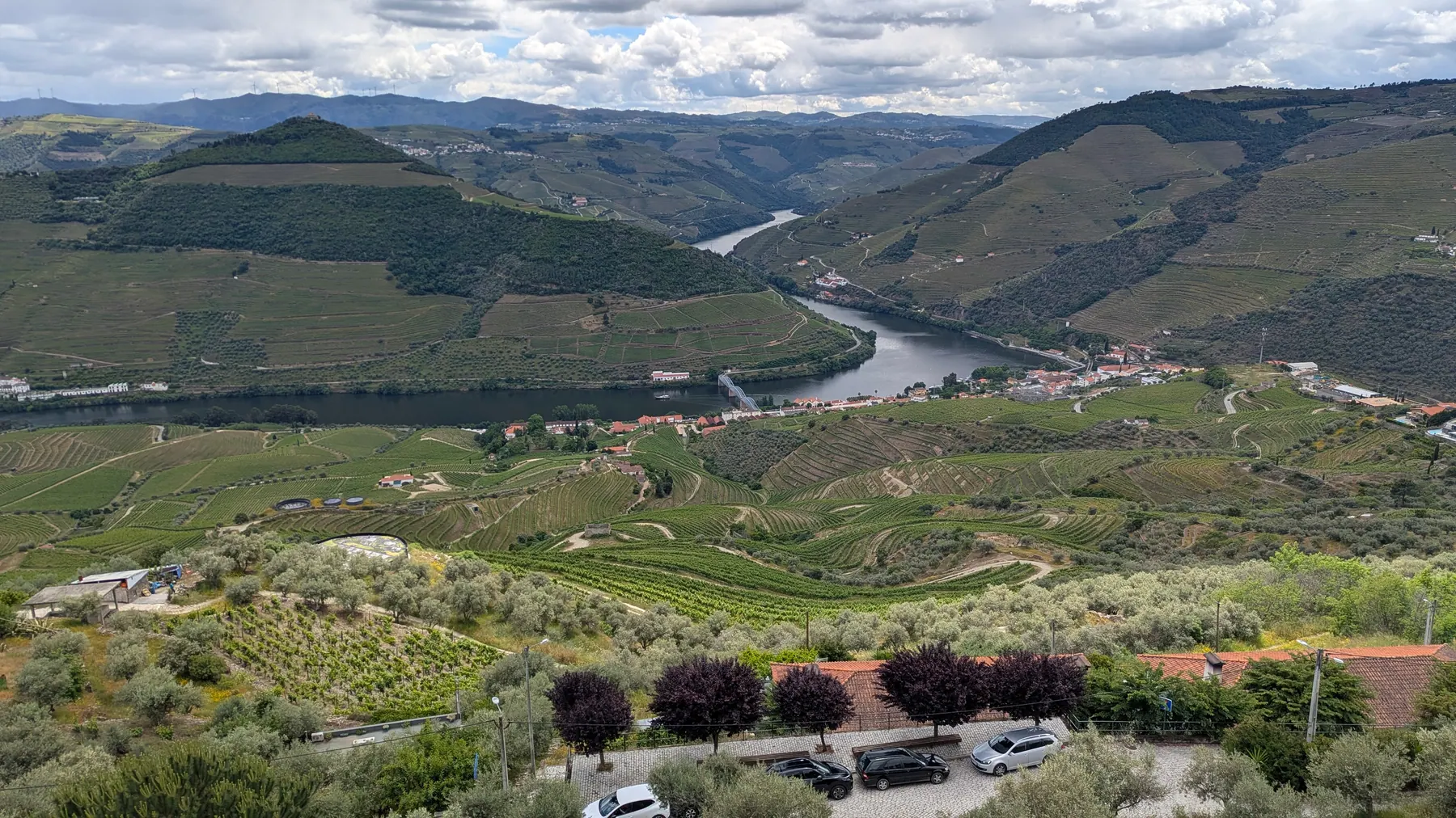 A panoramic view from Miradouro Casal de Loivos over Pinhão, the Douro River and terraced vineyards