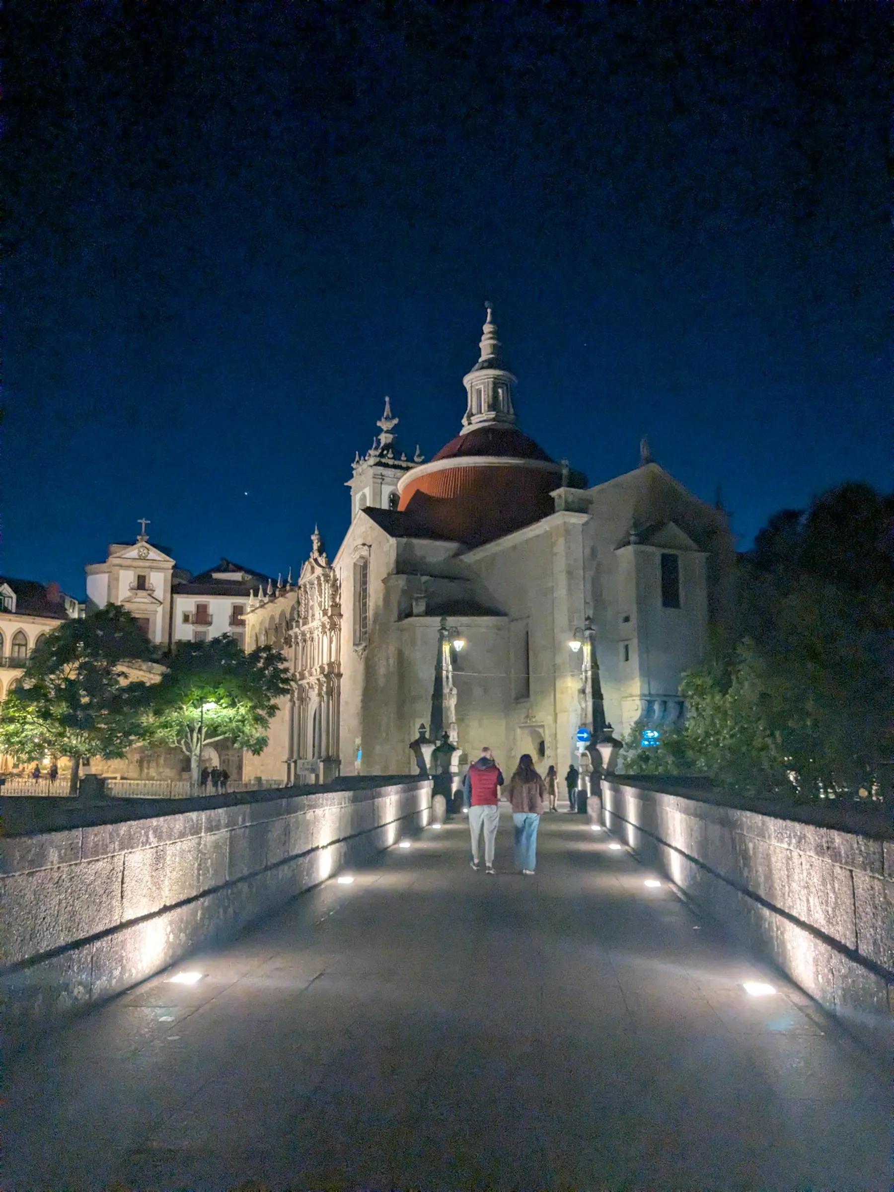 A lit church and bridge at night in Amarante