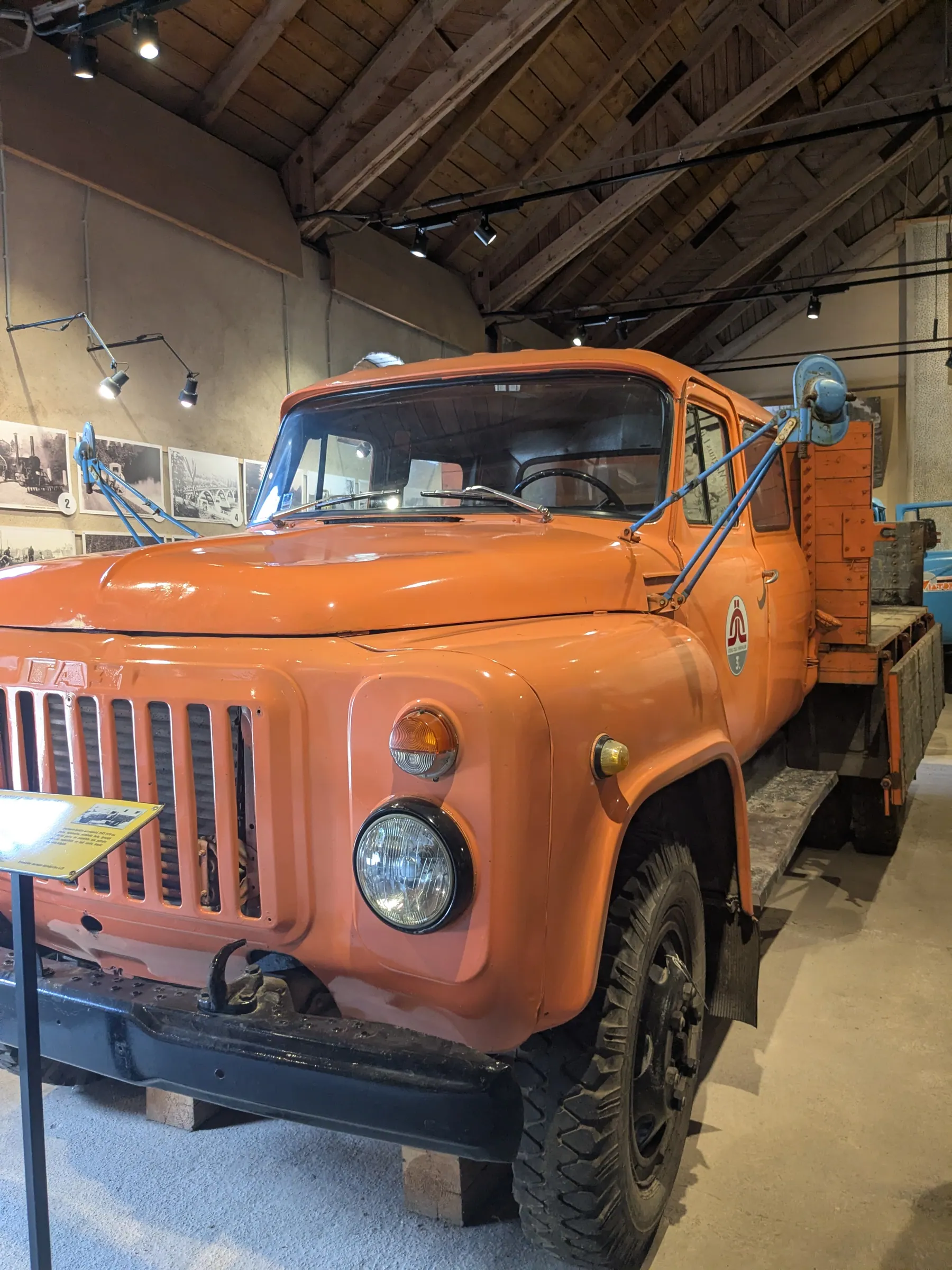 An orange historic vehicle inside the Latvian Road Museum