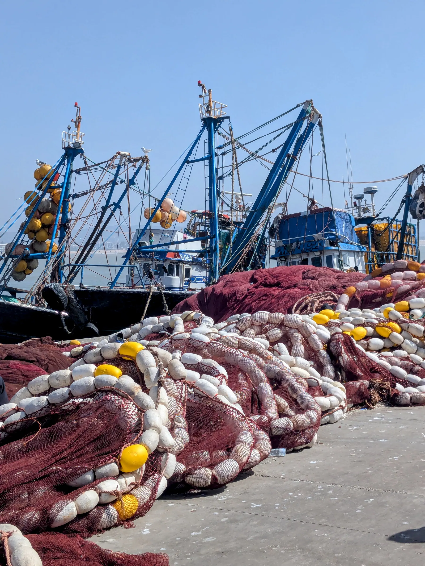 Fishing nets and boats in the working port of Essaouira
