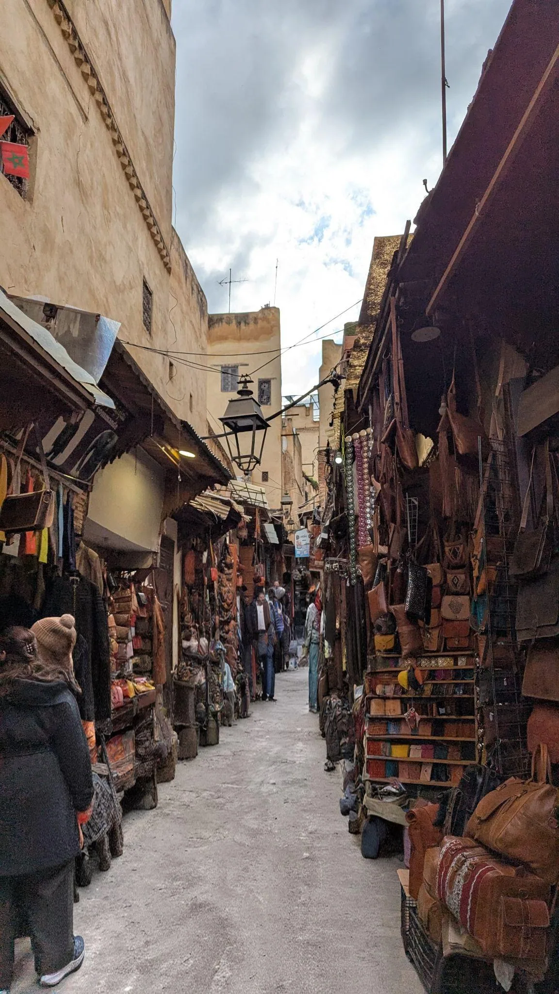 Leather bags and goods hanging in a Fez souk