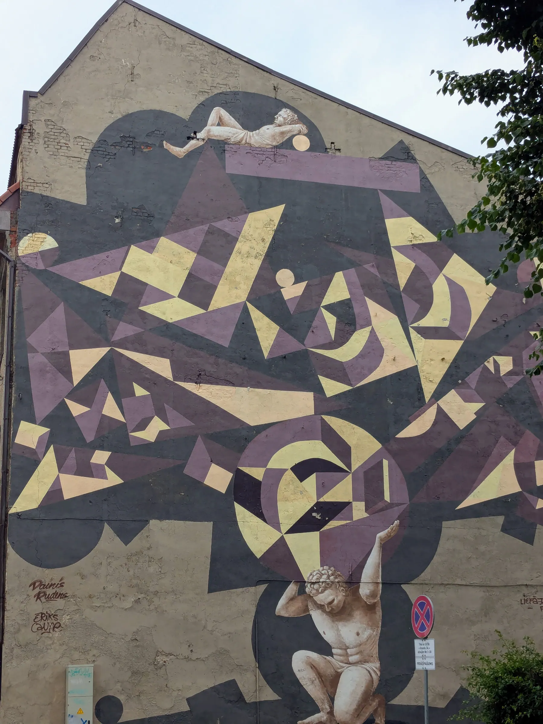 A geometric animal mural covering the side of a building in Liepāja