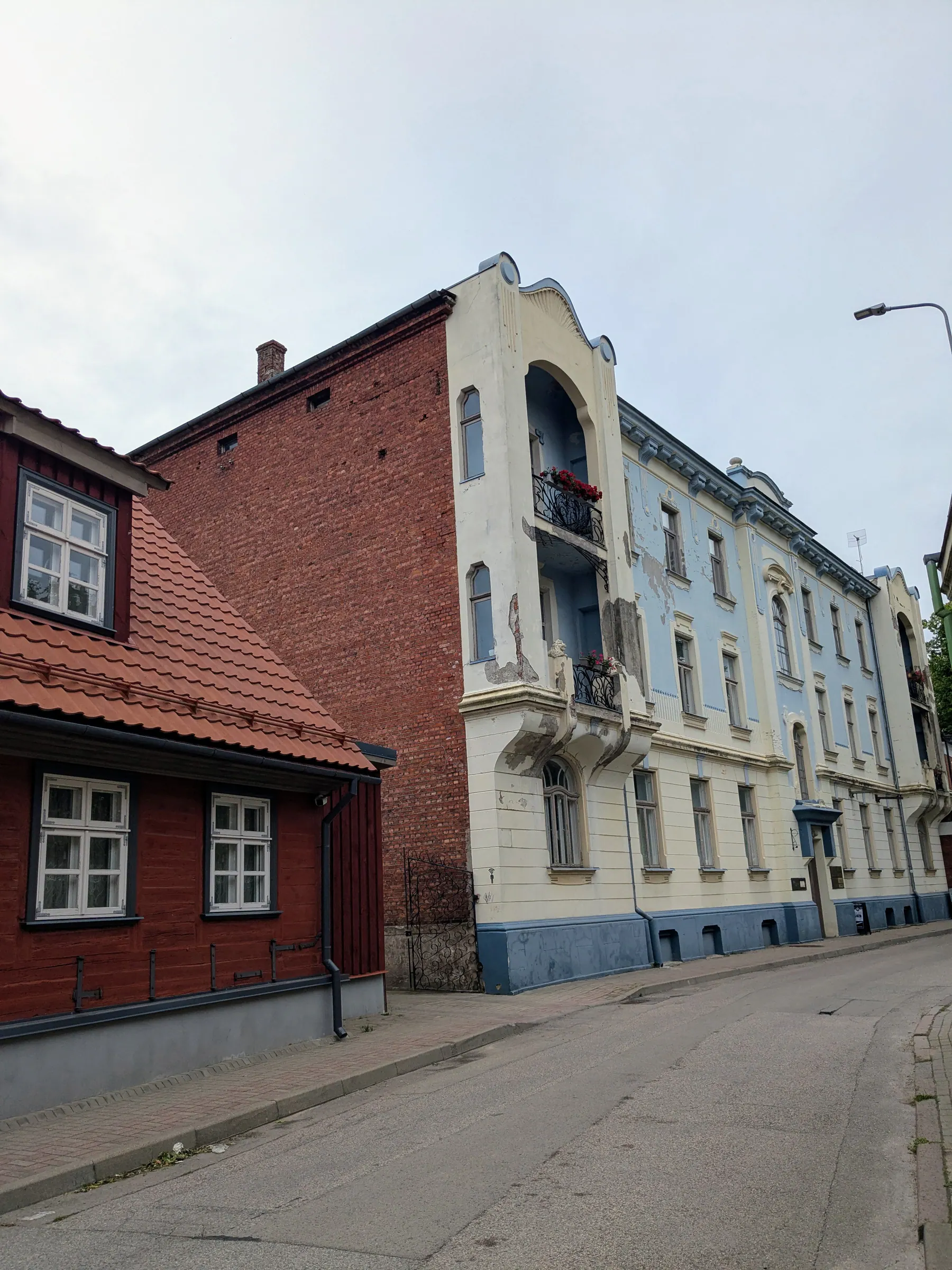Weathered historic buildings lining a quiet Liepāja street