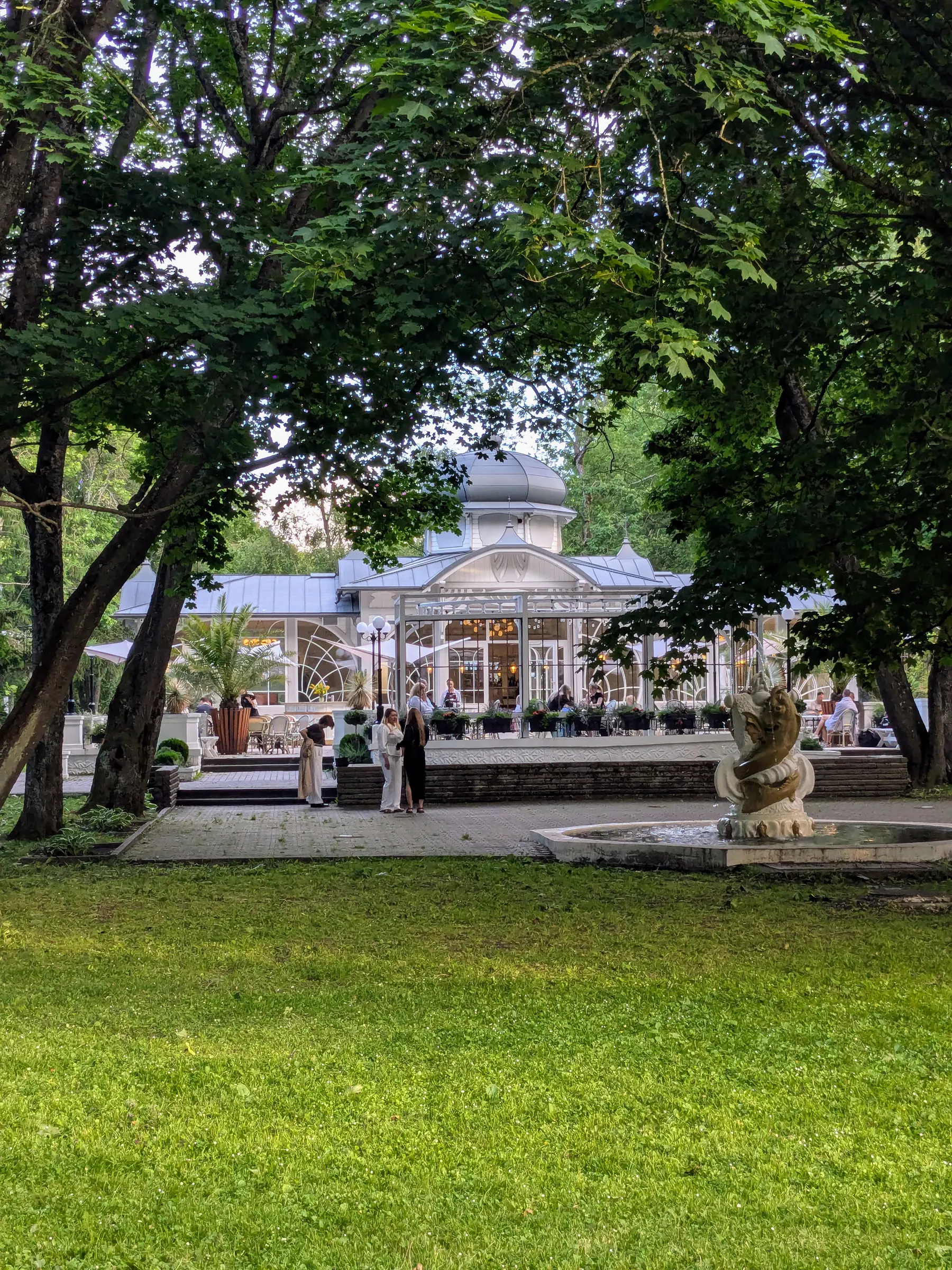 The white Pavilion building among trees in Liepāja Seaside Park