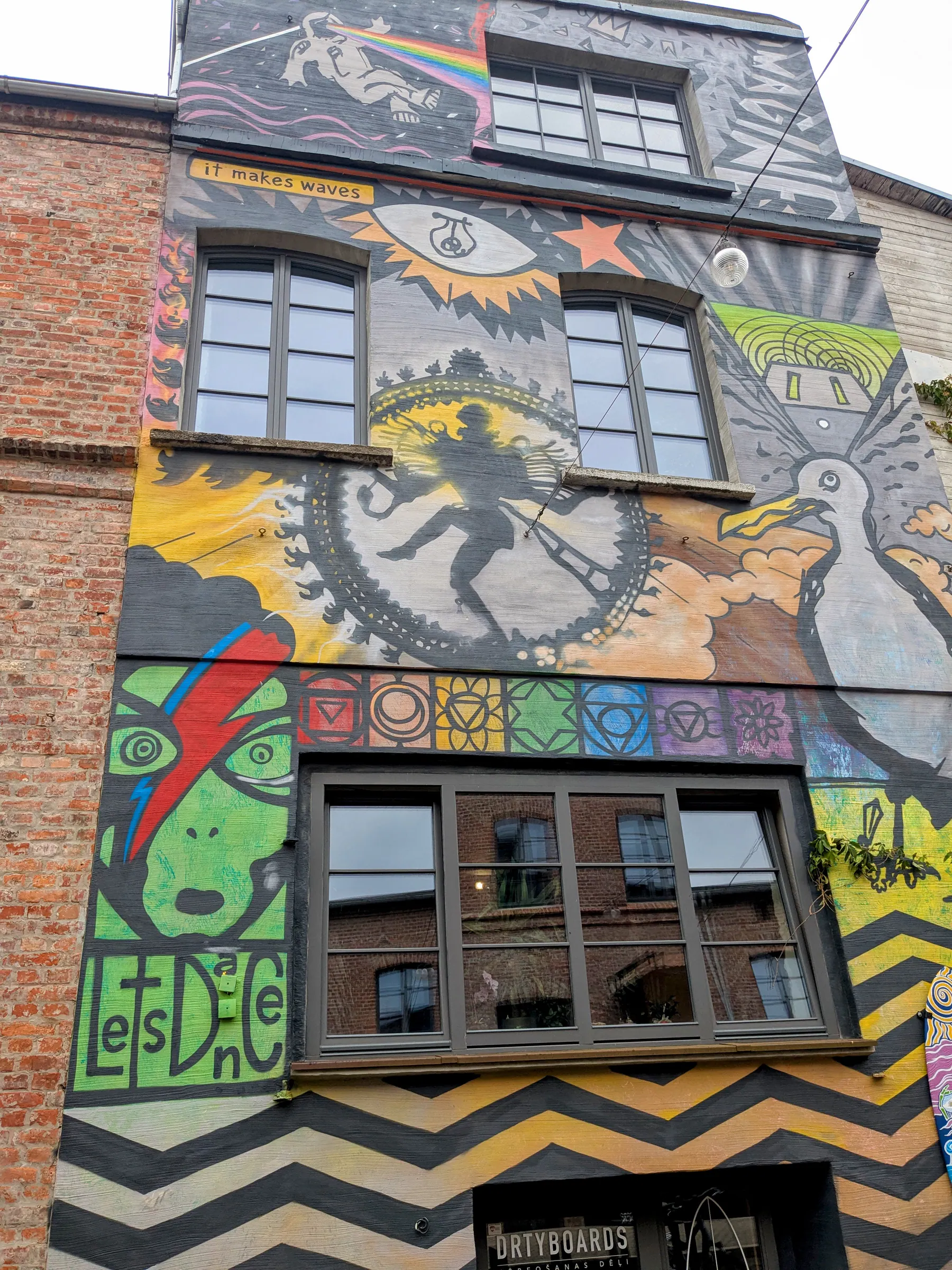 A mural-covered building in Juliannas kvartāls in Liepāja