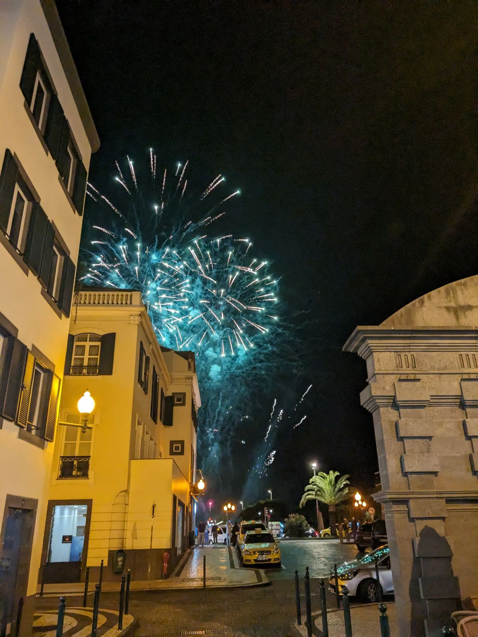 Fireworks above buildings in Funchal at night