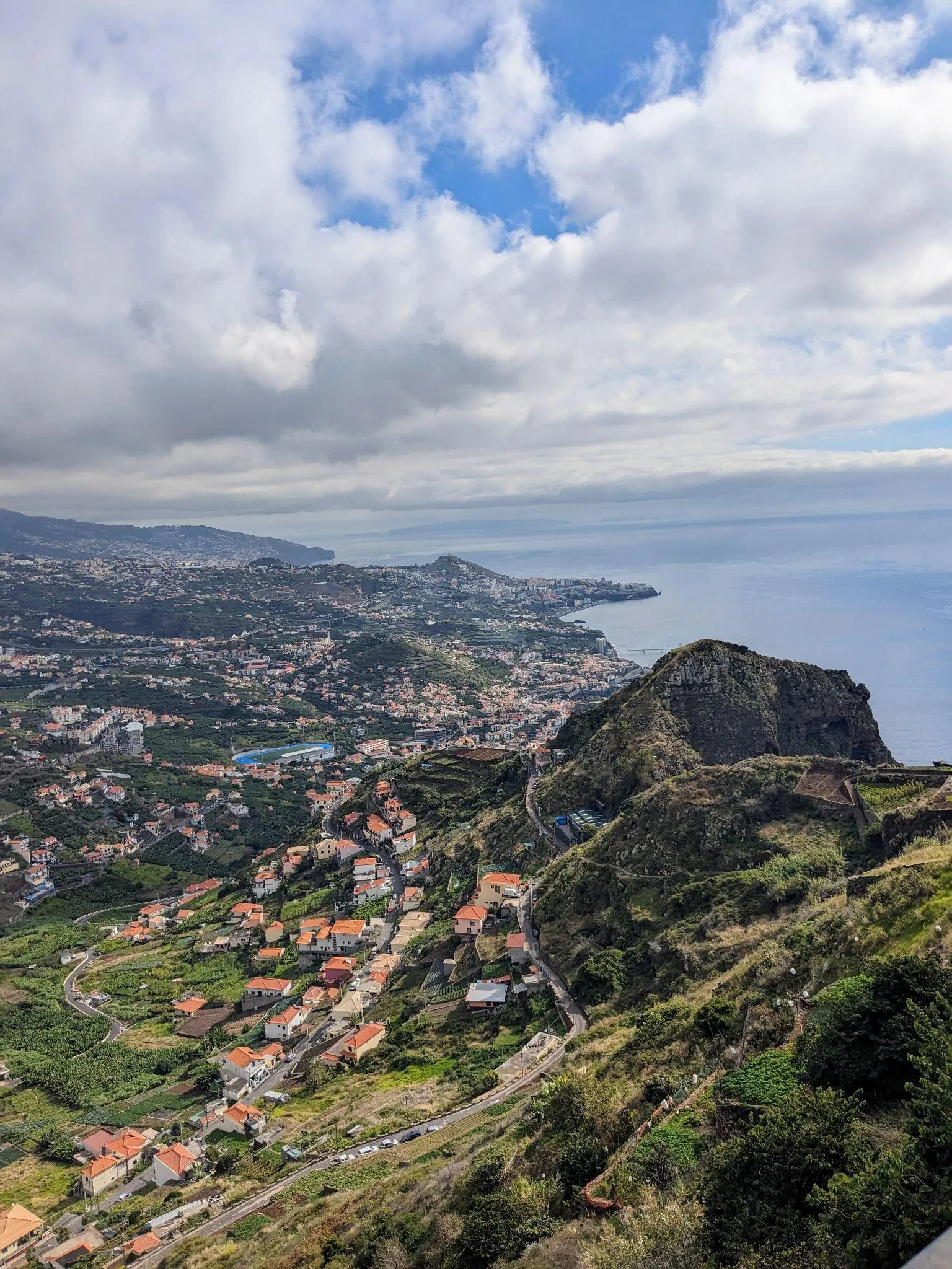 Coastal rooftops and cliffs below Cabo Girão in Madeira