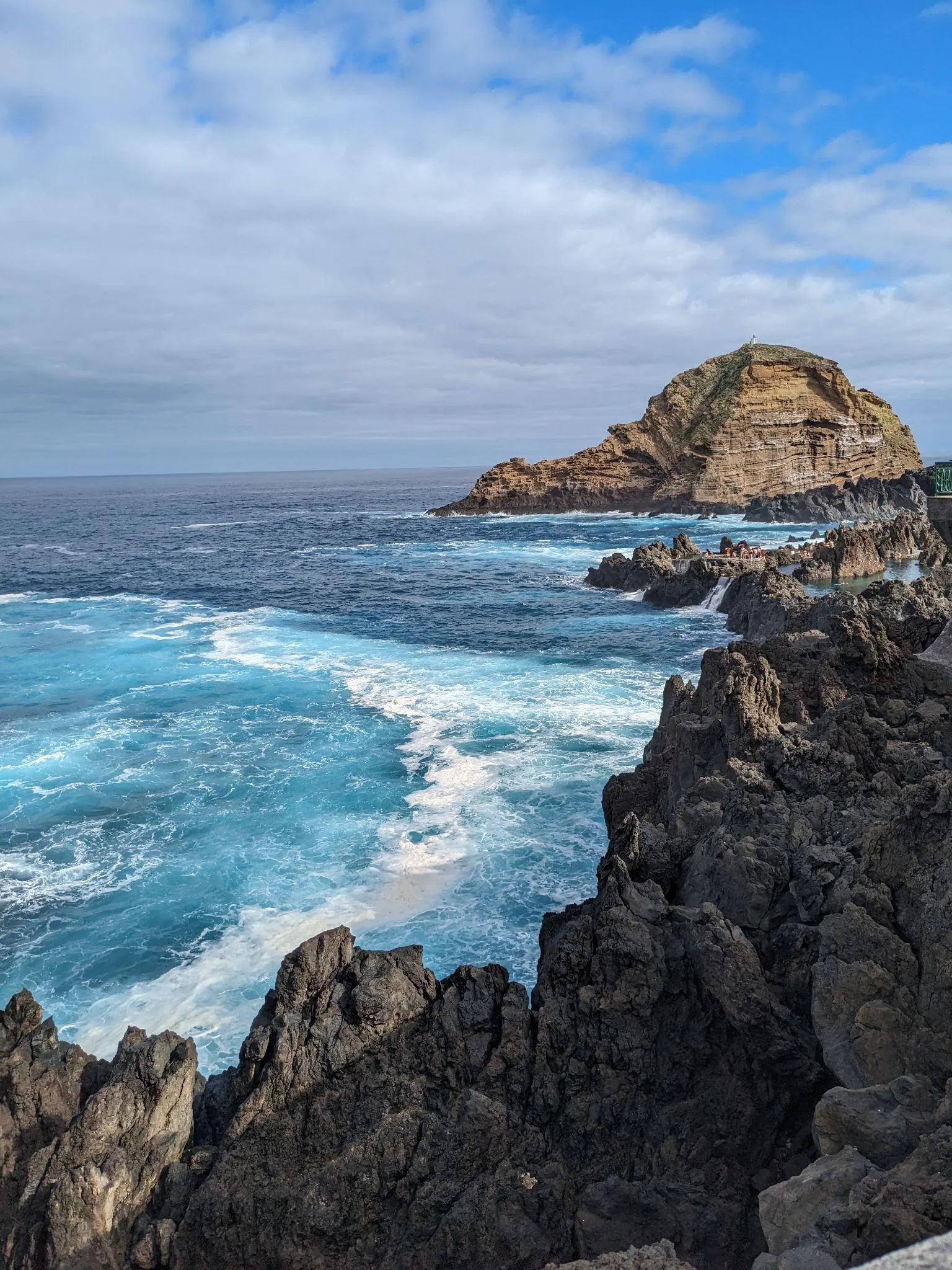 Waves crashing against black volcanic rocks at Porto Moniz