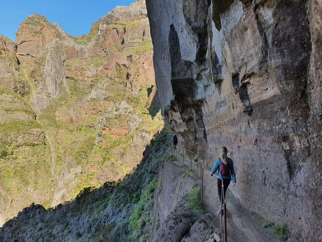 Hikers walking along the rocky Pico do Arieiro trail in Madeira