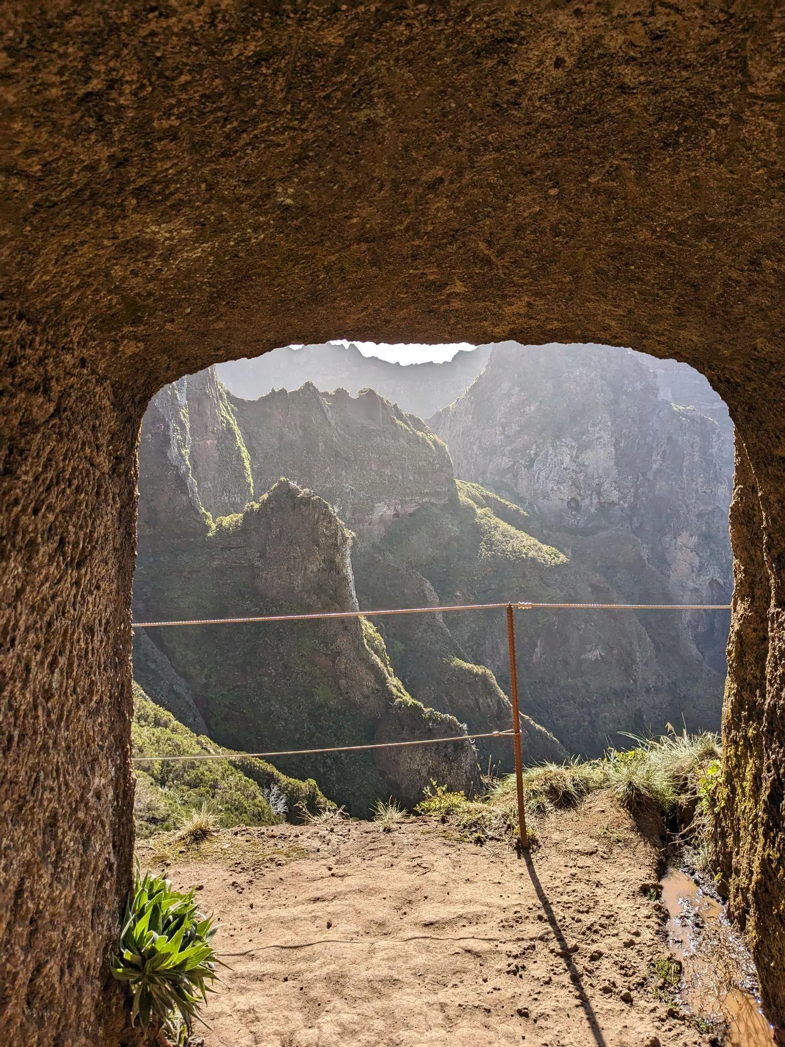 Mountain view framed by a tunnel on the Pico do Arieiro trail