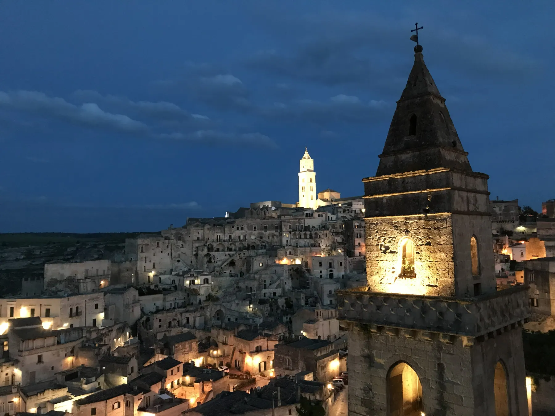 Matera's illuminated Sassi and cathedral ridge at night