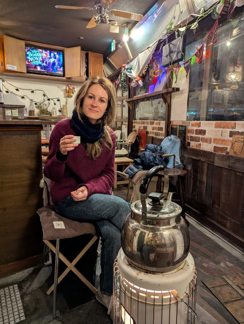 A traveller trying sake at Nikko Smile Bar and Coffee