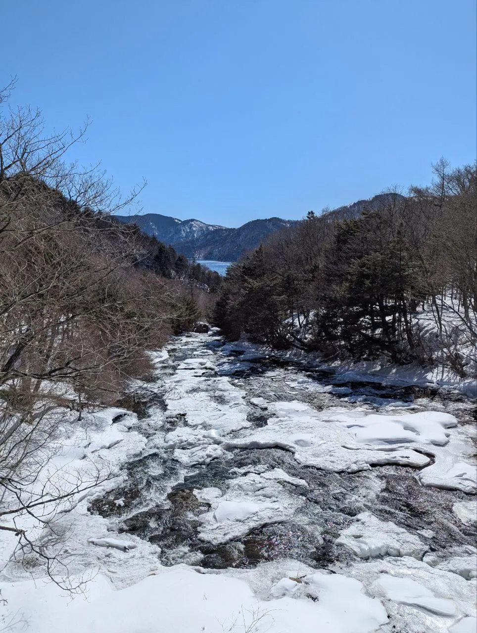 A winter stream running through the snow in Nikko
