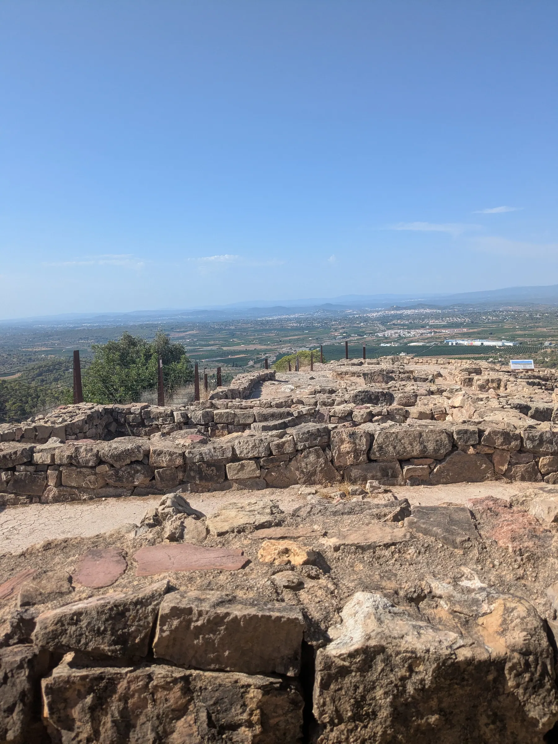 Stone foundations and the view from Puntal dels Llops