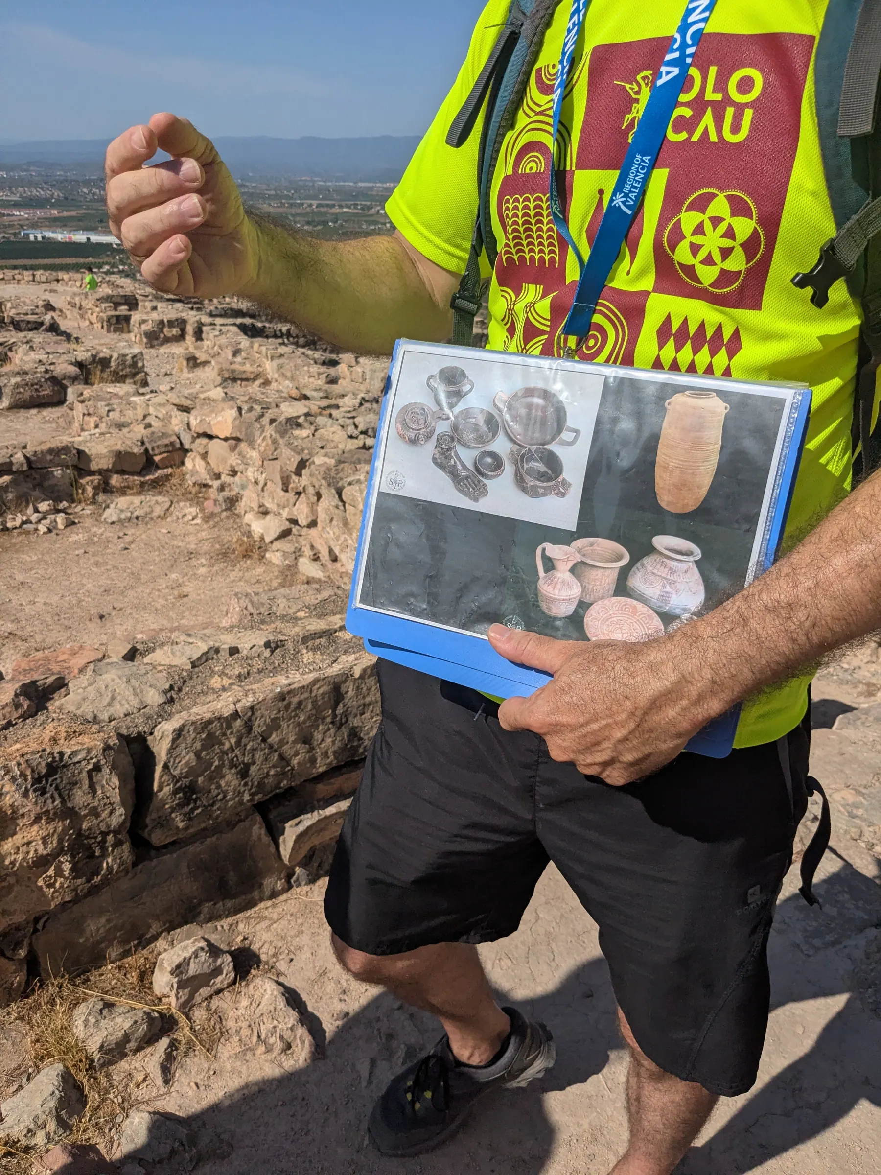 The archaeologist guide showing excavation material at Puntal dels Llops