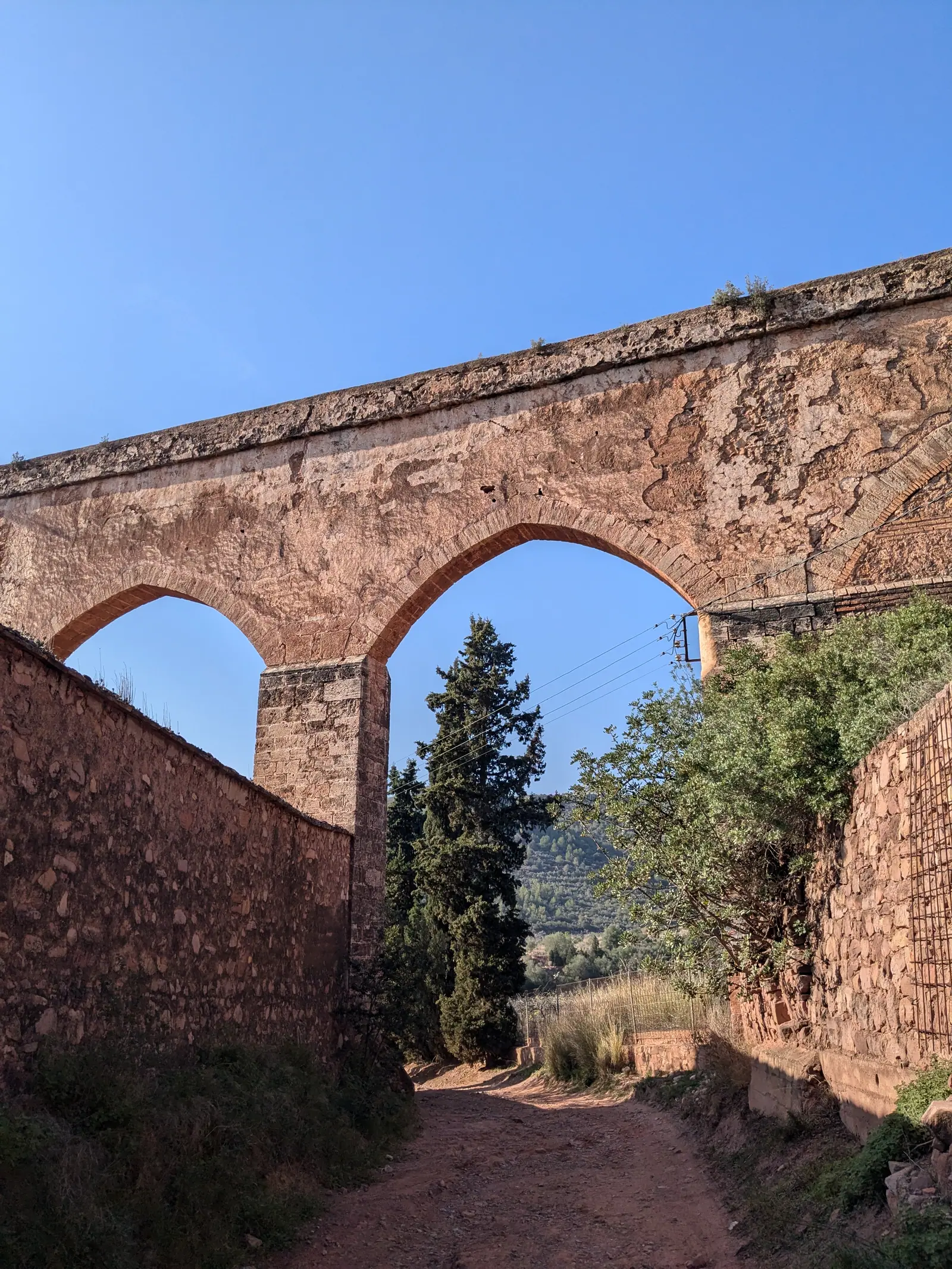 Stone arches of the Gothic aqueduct beside Portaceli