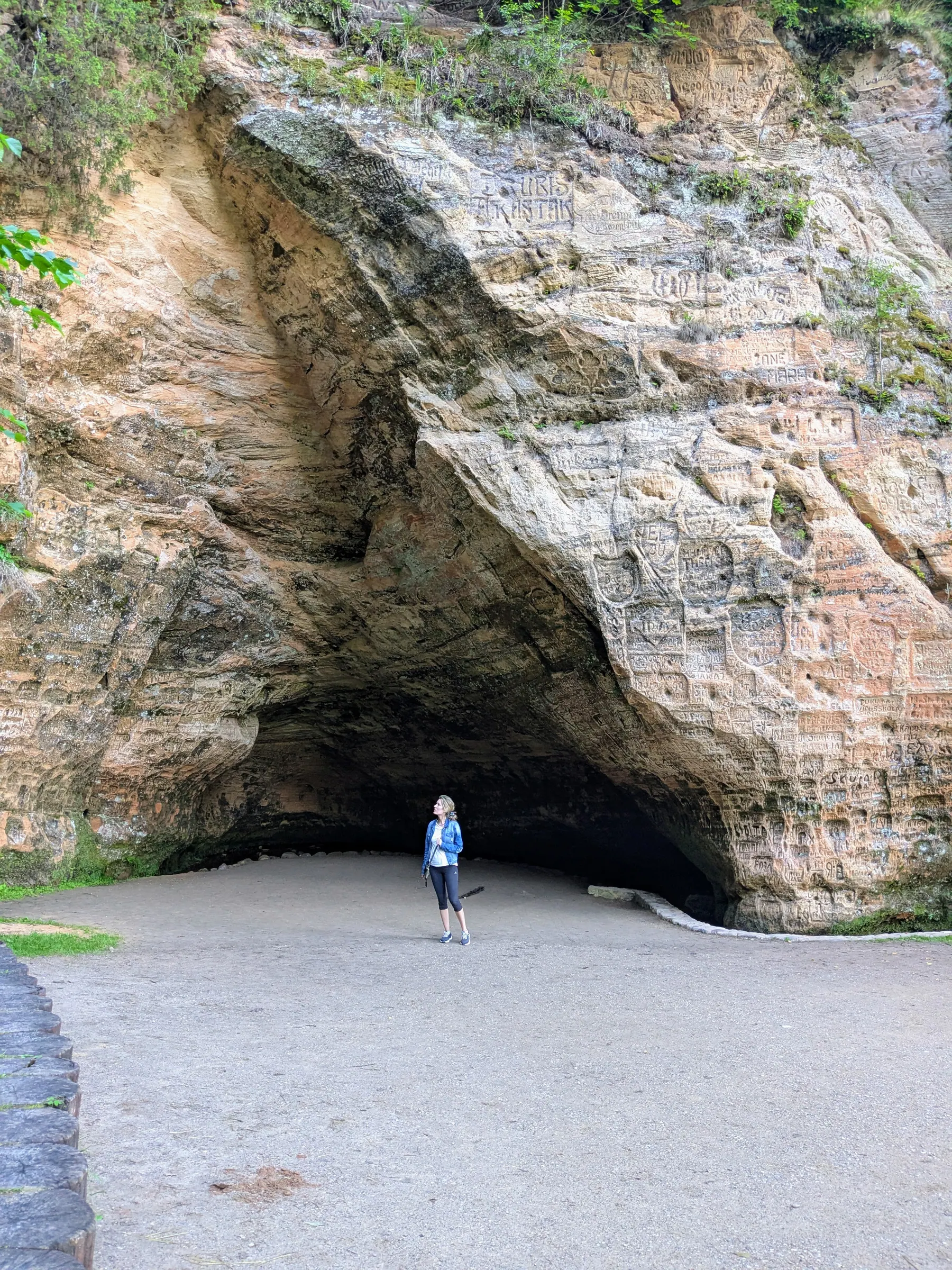 Historic inscriptions carved into the sandstone inside Gutmanis Cave
