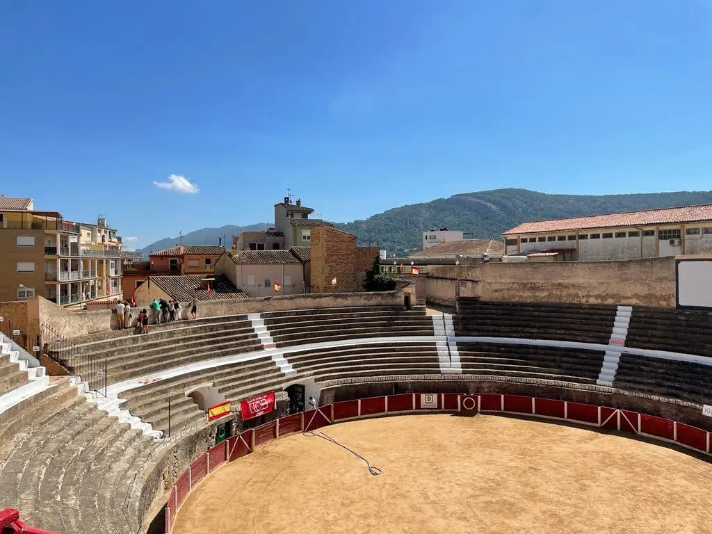 The circular arena and seating terraces of Bocairent bullring cut into the limestone hillside