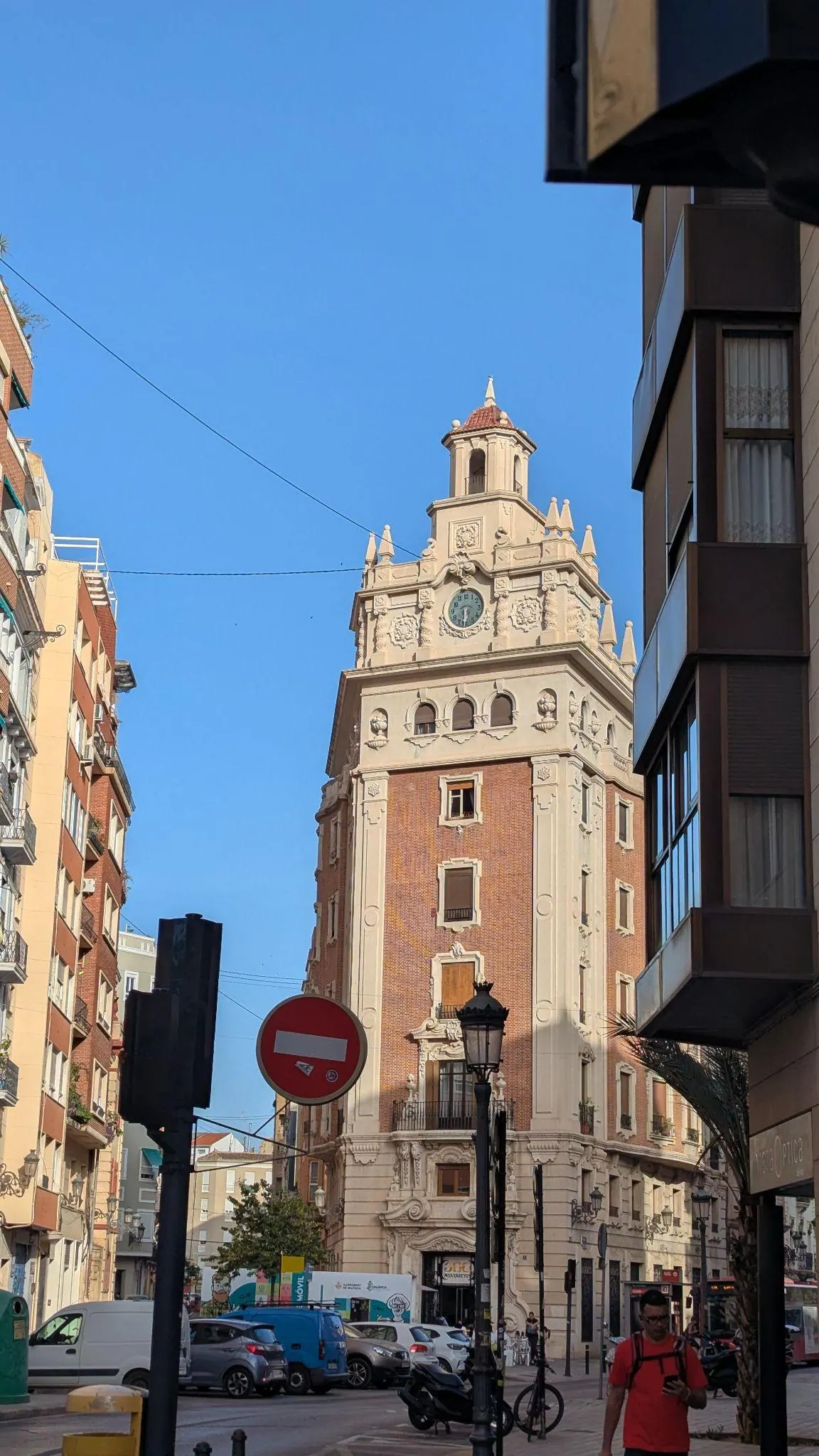 Sunlit street corner and lively neighborhood cafe terrace in Ruzafa