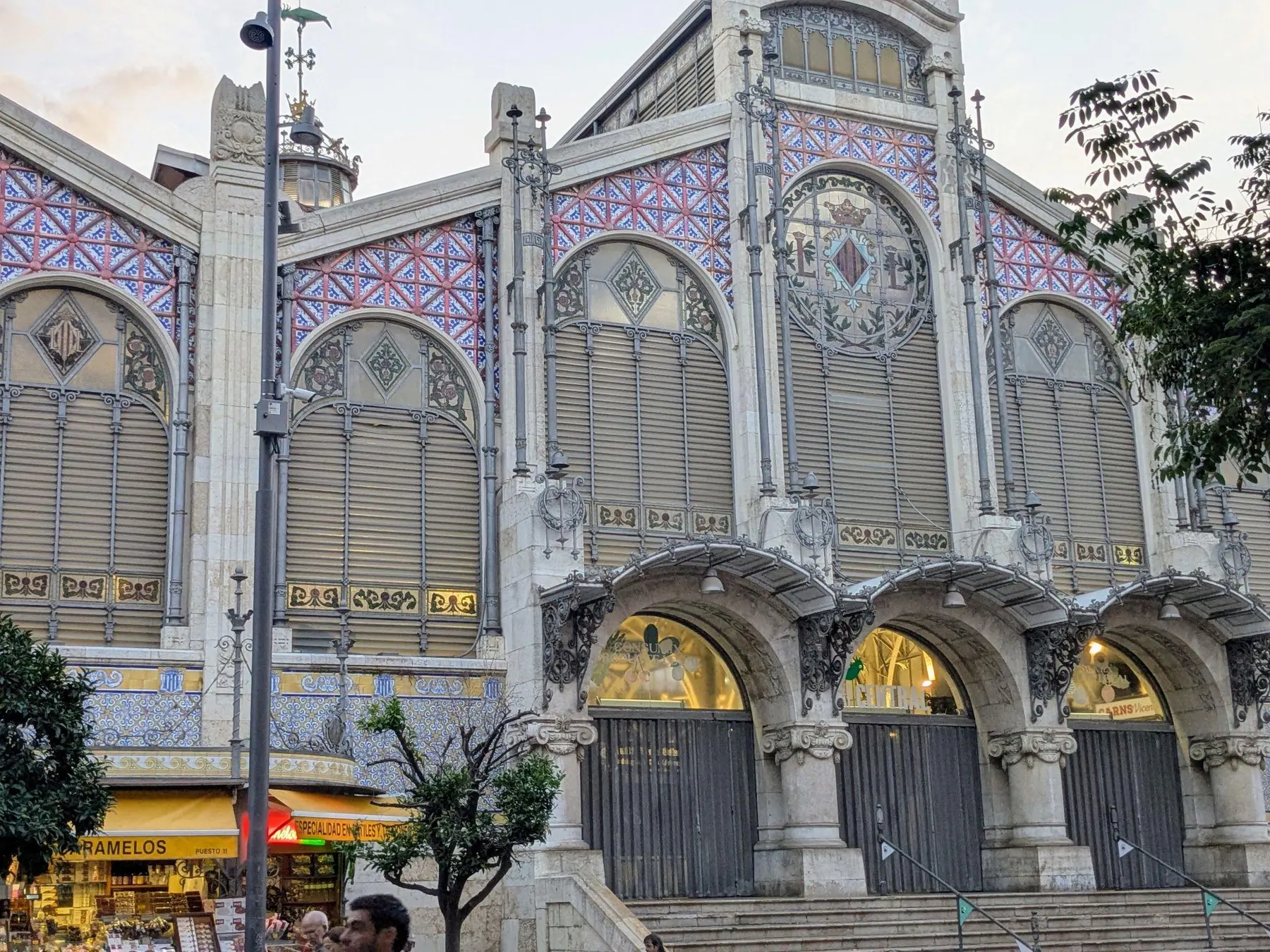 Bustling fresh produce stalls and iron dome ceiling inside Mercado Central de Valencia