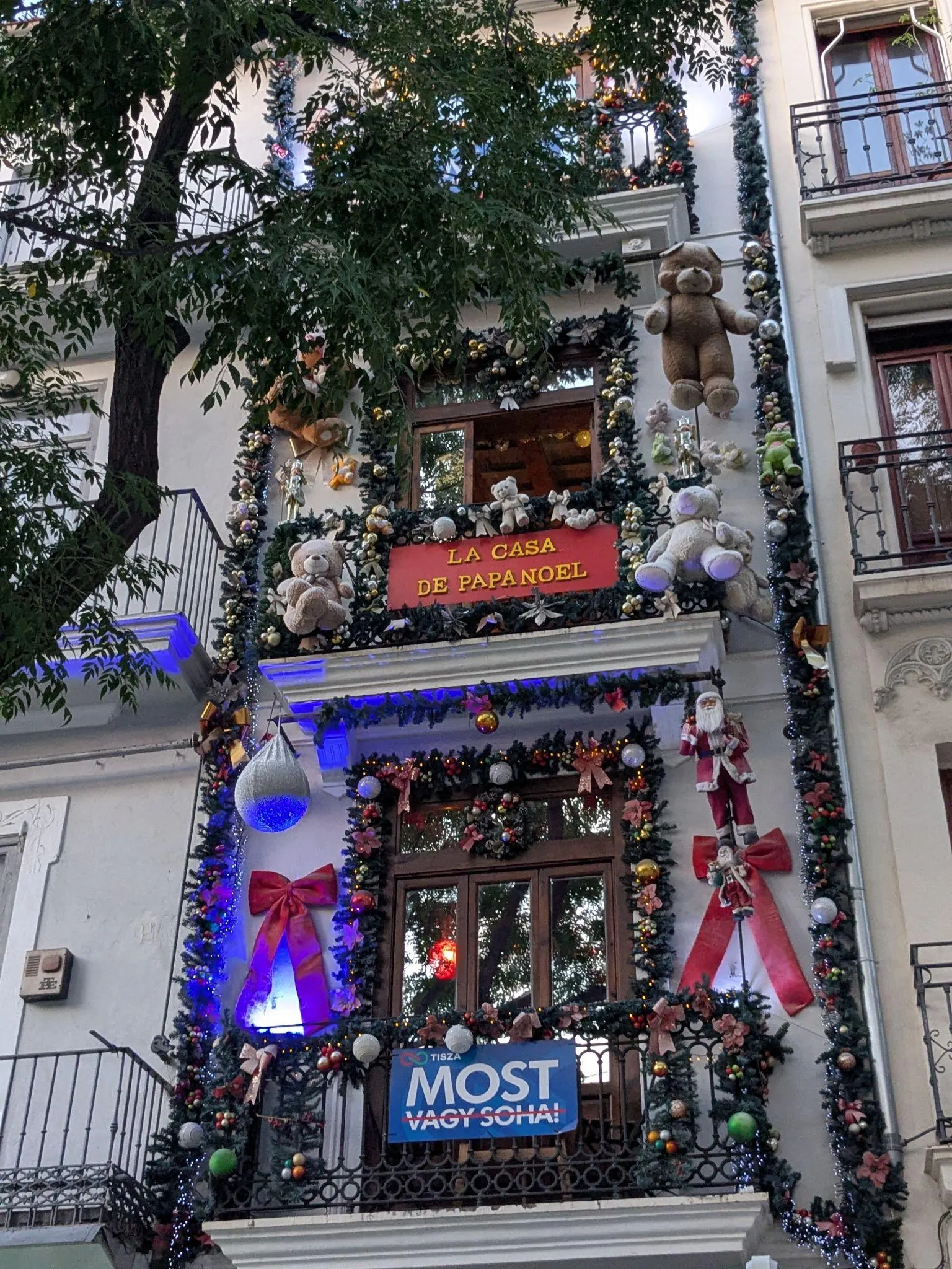 Festive building facade decorated with teddy bears, garlands, and La Casa de Papa Noel sign on Plaza del Mercado