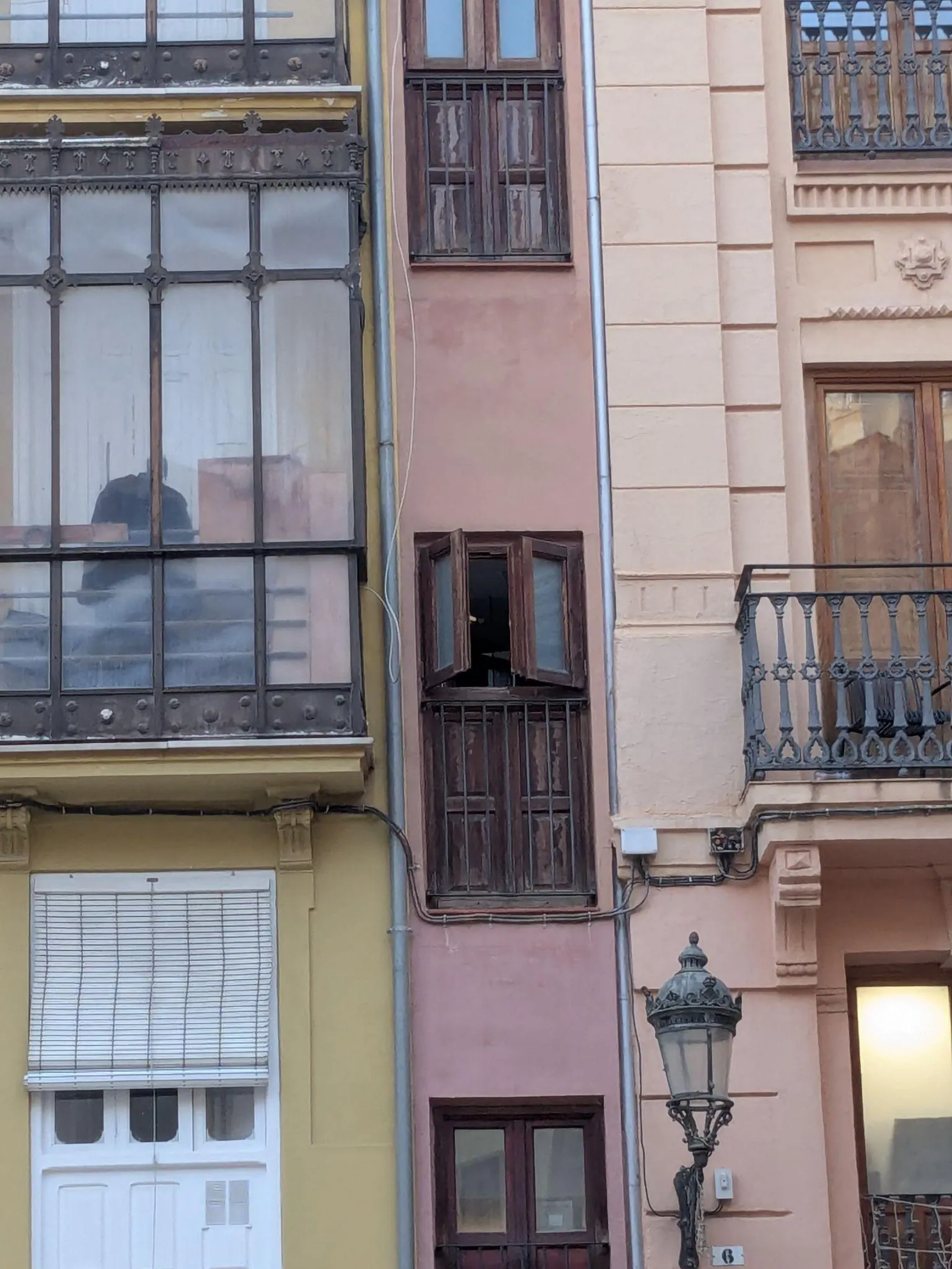 Extremely narrow five-story terracotta facade of La Estrecha facing Plaza Lope de Vega