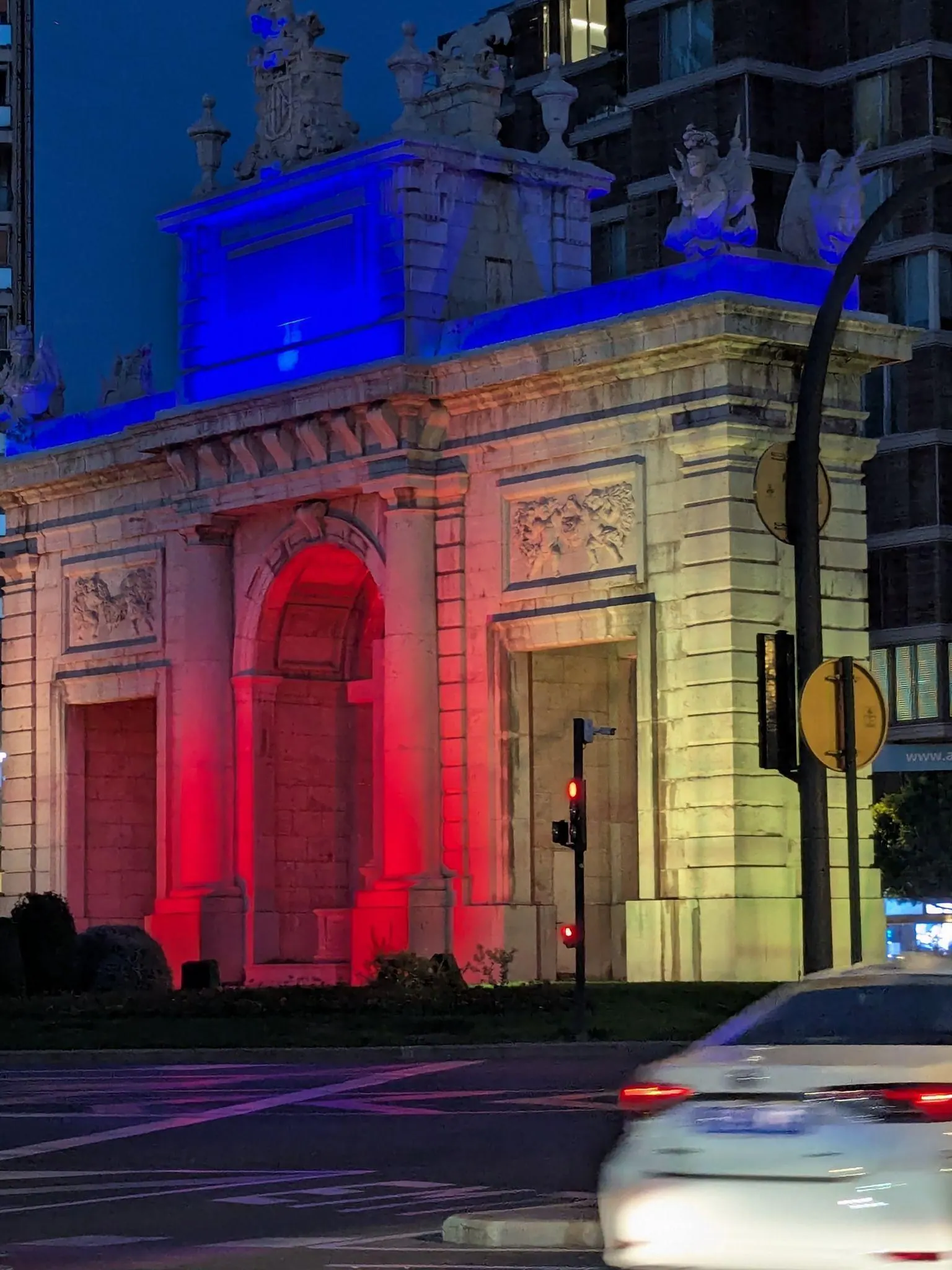 Neoclassical stone triumphal arch of Puerta de la Mar surrounded by landscaped city gardens