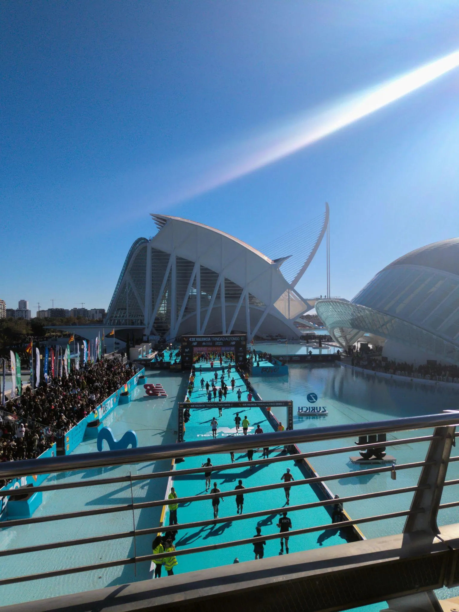 Runners participating in the marathon crossing the footbridge pools at the City of Arts and Sciences